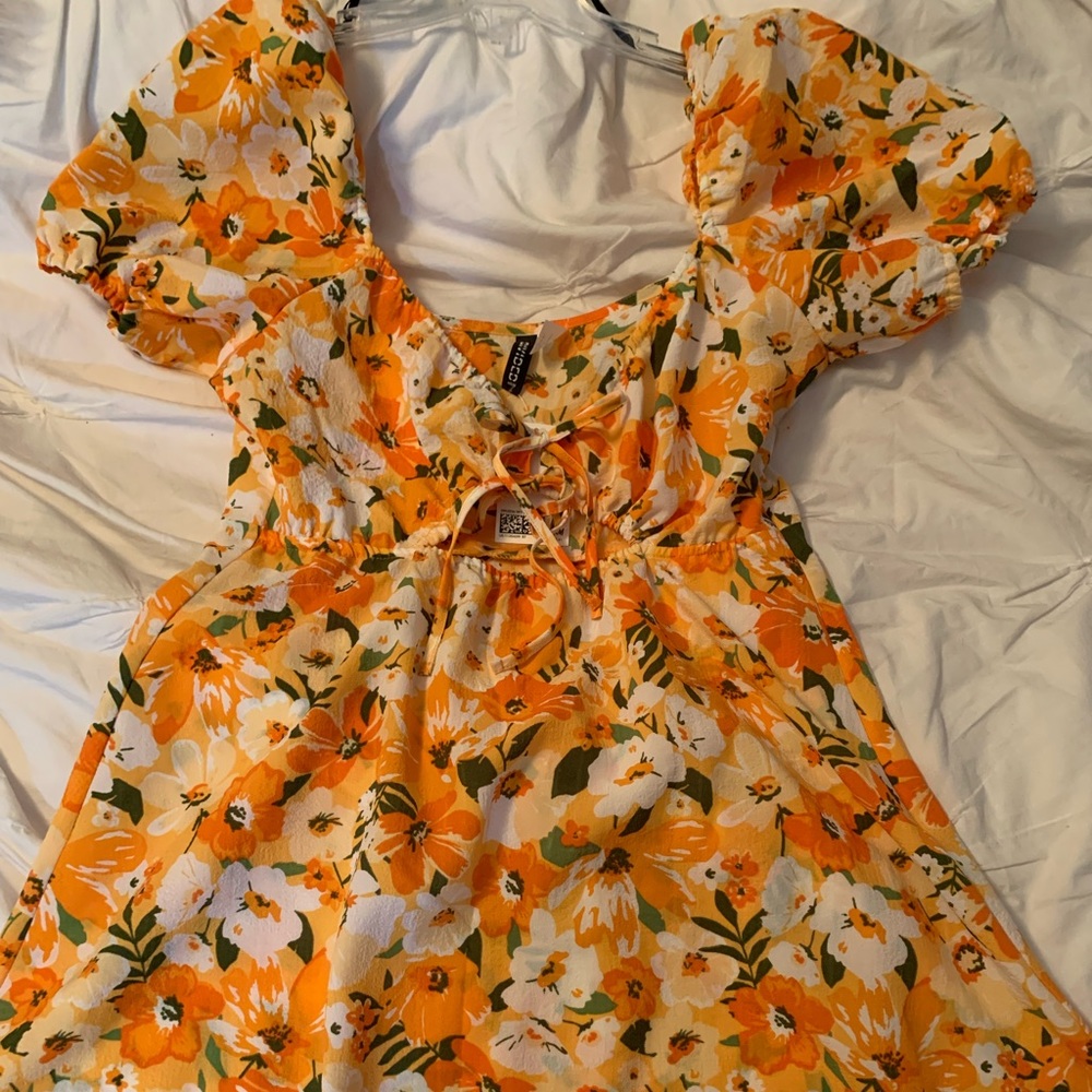This is an orange and yellow puff sleeve mini dress from H&M size Medium